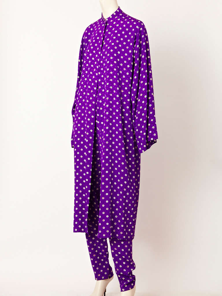 Halston, fouled print, silk coat and pant ensemble. Supple, purple, printed silk,
coat with a mandarin collar and single button closure at the neck. Pant is slim,
with an elastic waist.