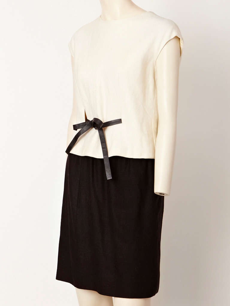 Norman Norell, black and white linen top and skirt ensemble. Top is ivory linen,
with a cap sleeve and rounded neckline with a  leather 