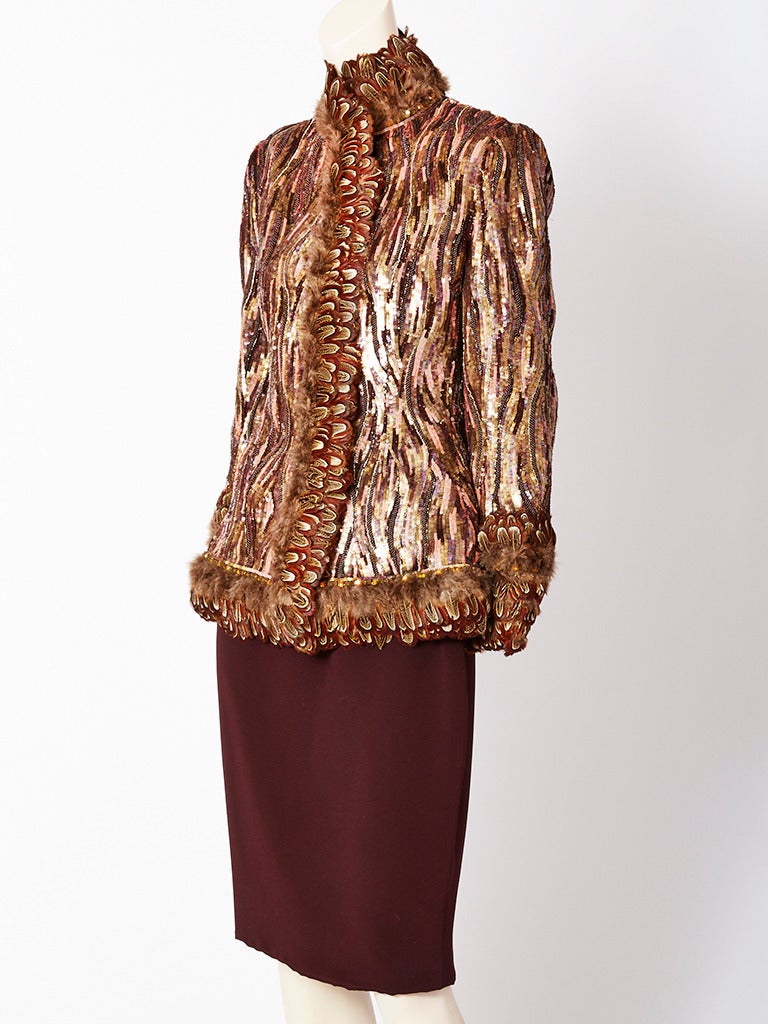 Bill Blass copper tone, fitted, dinner suit, encrusted with sequines and beads 
having feather trim along the neckline, cuffs, center front and hem.
Sequins and beading create a pattern that echoes the feathers.
Straight skirt is in a chocolate