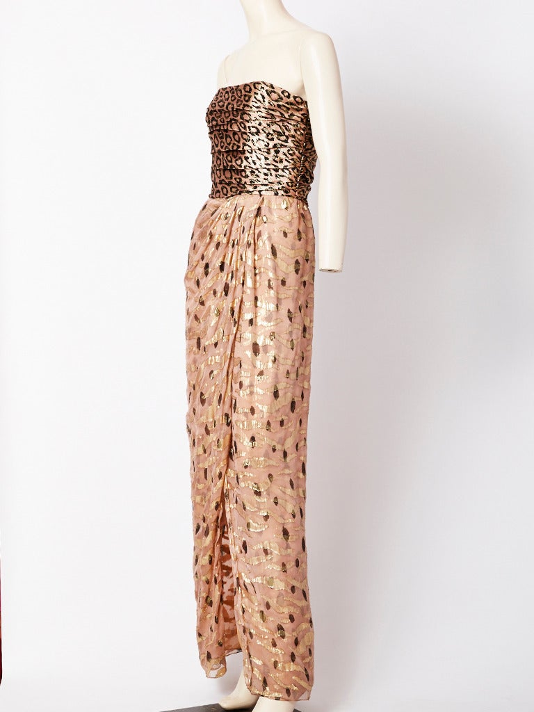 Bill Blass, Strapless, lame and chiffon evening gown, having, a shirred, leopard print lame bodice and a printed chiffon and lame print tulip shaped skirt with opening in the front.