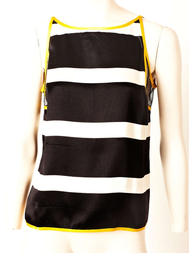 Geoffrey Beene, buttery soft, Chrome, yellow, bomber jacket with a satin black and white horizontal stripe tank top. Jacket has a hidden industrial zipper and is lined in the same horizontal black and white stripe satin as the top.
Tank is trimmed