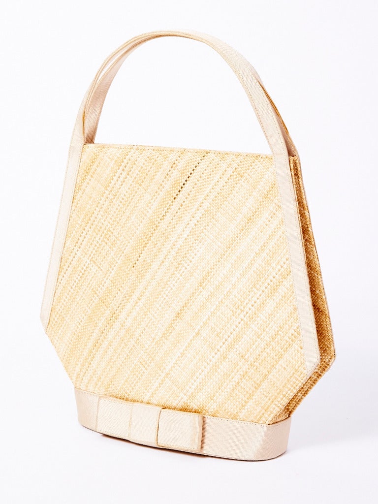 Guy Laroche, natural tone, raffia and gross grain summer handbag with bow motif at the base. Label reads Guy Laroche couture.