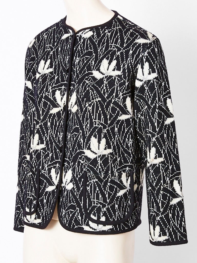 Yves Saint Laurent, jacquard, knit, floral print, cardigan with a touch of silver shimmer in the knit.
Cardigan is trimmed in black having front with pockets.