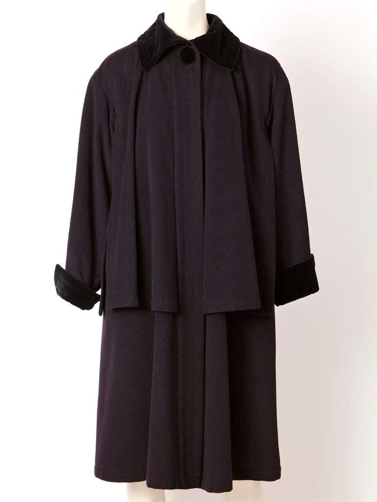 YSL, wool tiered coat with velvet collar and cuffs. Coat has a removable cotton
treated cape that acts as a protective from the rain.