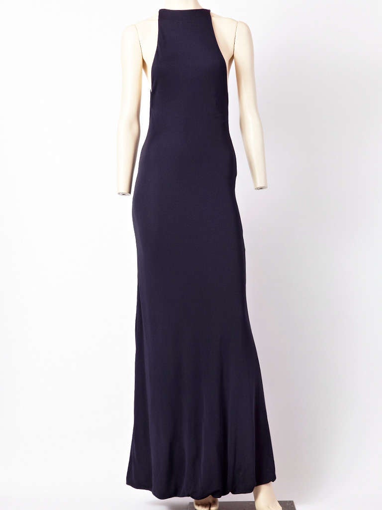 Halston, ink blue double faced halter neck bias cut gown with cape. Cape, slips over the head with a slit on one side for ease of movement. C. 1970's.