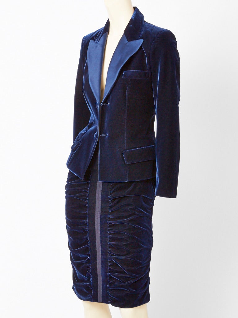 Tom Ford for YSL, midnight blue, velvet tuxedo, skirt suit.
Jacket is fitted with a satin and velvet, lapel collar.  Flap side pocket detail.  Skirt is narrow with ruching detail down the middle front and middle back.