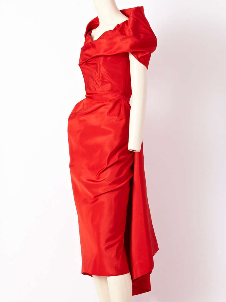 Charles James, ca. 1950
Dinner Dress, often referred to as the Spiral Dress
Red silk faille
Extremely rare example

Like a red-hot cyclone, a spiral emanates from a central point on the hip. The fabric then angles off the straight grain as the