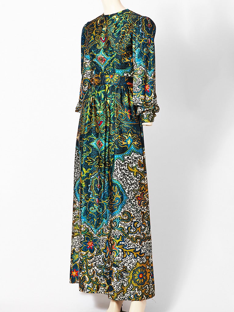 Oscar de la Renta, silk sateen, medallion print, long sleeve, collarless, maxi dress with matching belt. Print has background shades of teal blue and greens.
Late 60's.