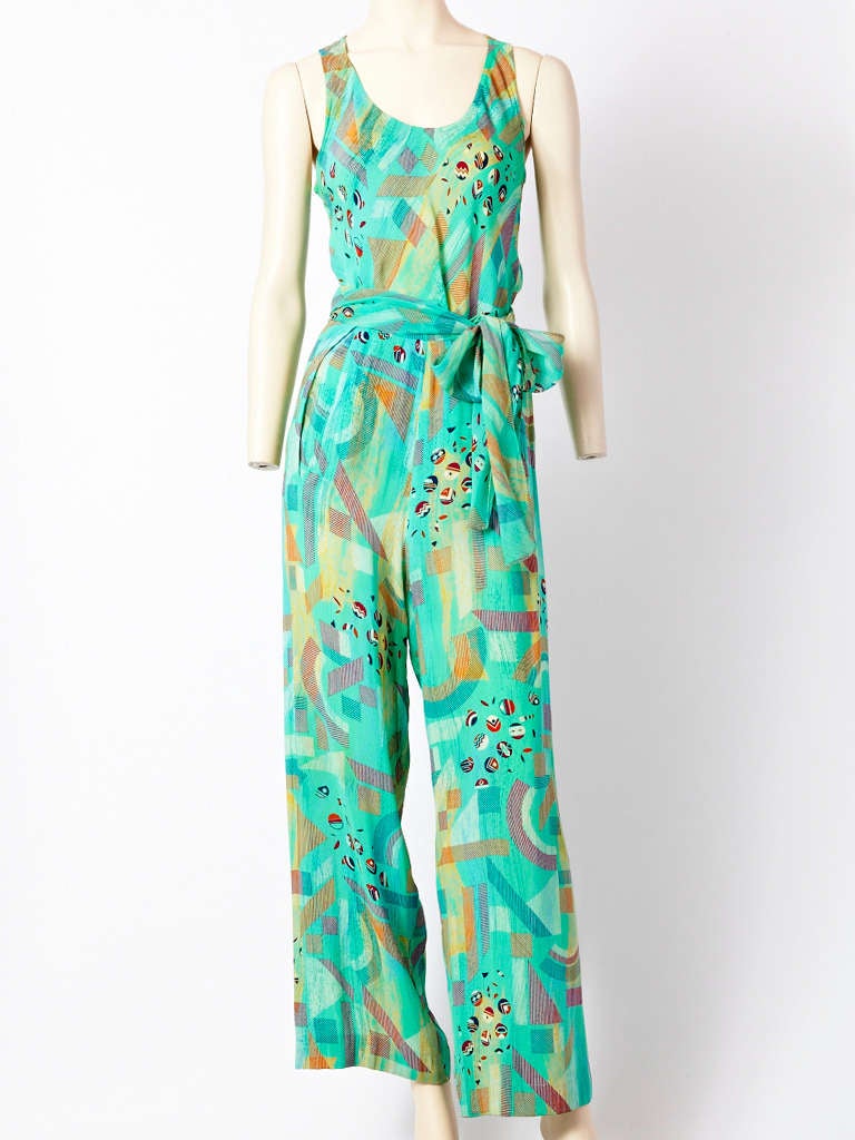 Stephen Burrows, colorful, printed 3 piece ensemble consisting of a jacket, tank top, pant and sash. Jacket is a short sleeve cardigan ending at the hip, in a Georgette. Tank top is bias cut. Trouser is wide legged. C. 1970's.