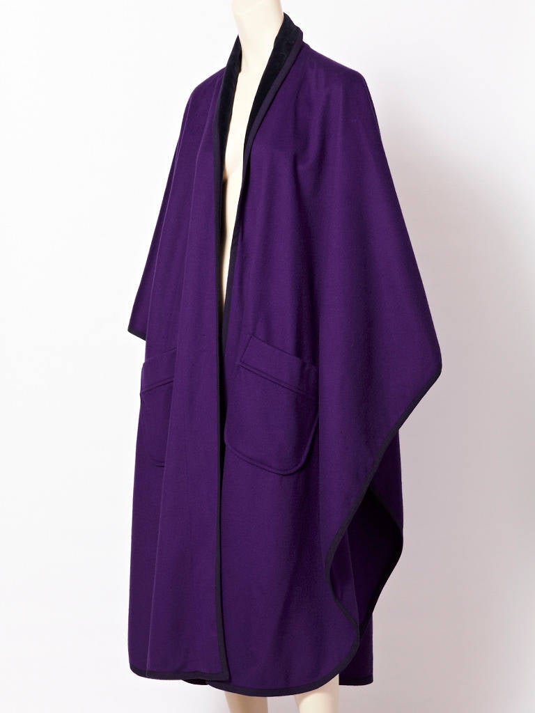 YSL, purple, wool, oversize, long poncho/cape with large patch pockets, edged in black braid and velvet collar. Velvet extends along the interior edge of poncho.