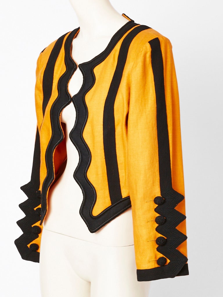Yves Saint Laurent, mustard, linen cropped, Matador inspired jacket with wide,
Passementerie trim. The trim gives the jacket some weight, and the linen is also heavy weight making the jacket seasonless. Wonderful zig zag trim at the sleeve cuffs.