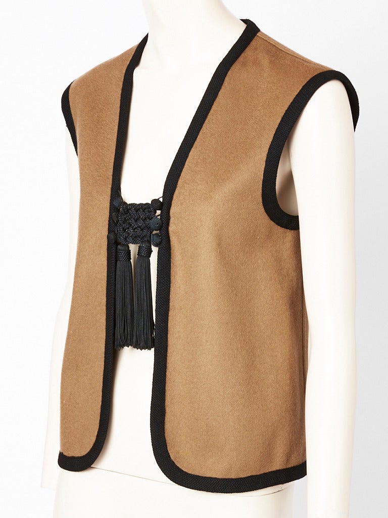 Yves Saint Laruent, Rive Gauche, taupe tone, wool sleeveless vest with black 
Passementerie and  Chinese inspired tassel closures. C. 1970's.
