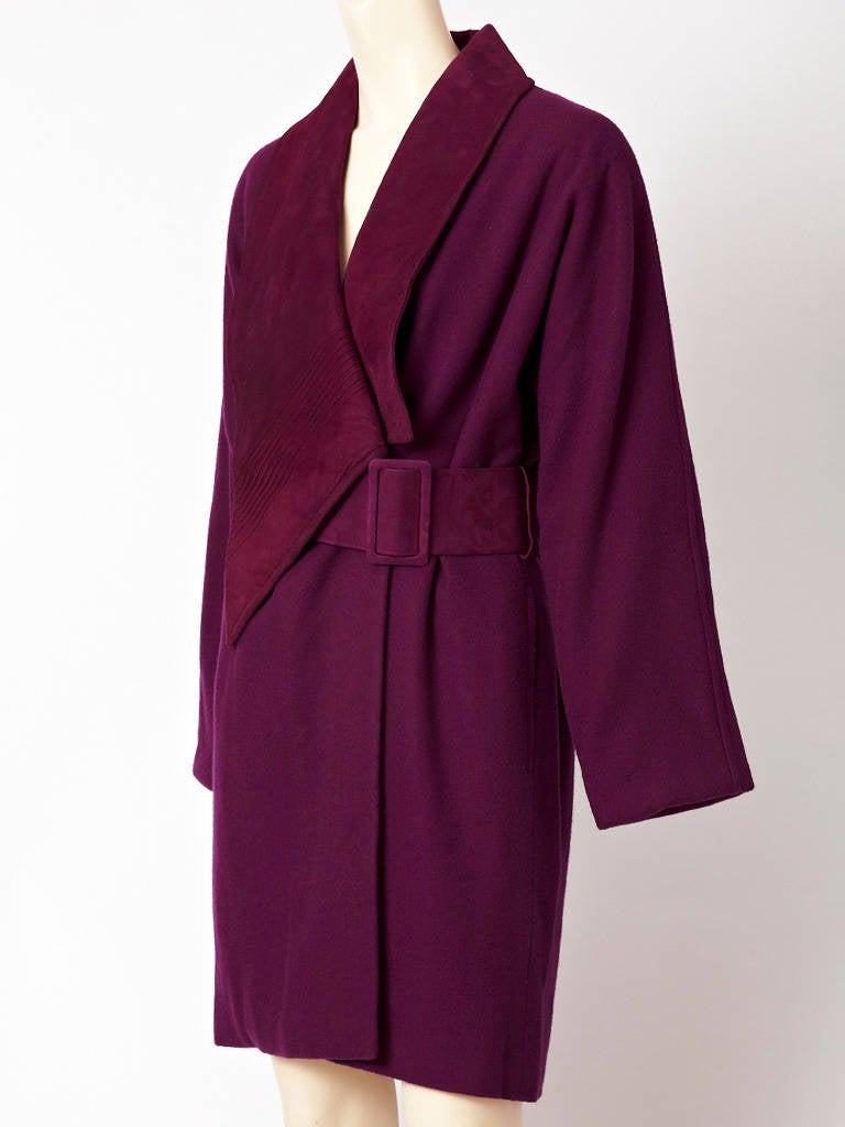 Shamask, purple. wool coat with off center closure and wide suede belt.
Suede collar is long and wide with the left side that comes to a point over the belt. Collar has stitched welting detail