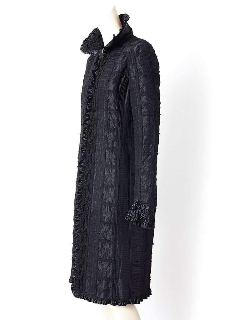 Oscar de la Renta, black, tafetta, victorian inspired , evening coat, with rounded collar, and an embellished body of pleated satin ribbon edging,  silk knots, and soutash embroidery. Coat closes with a front zipper.