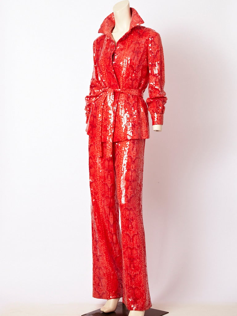 Bill Blass orangey-red sequined, reptile print,  evening pant ensemble. Top is like a shirt and is belted. Straight pant has a slight flare.