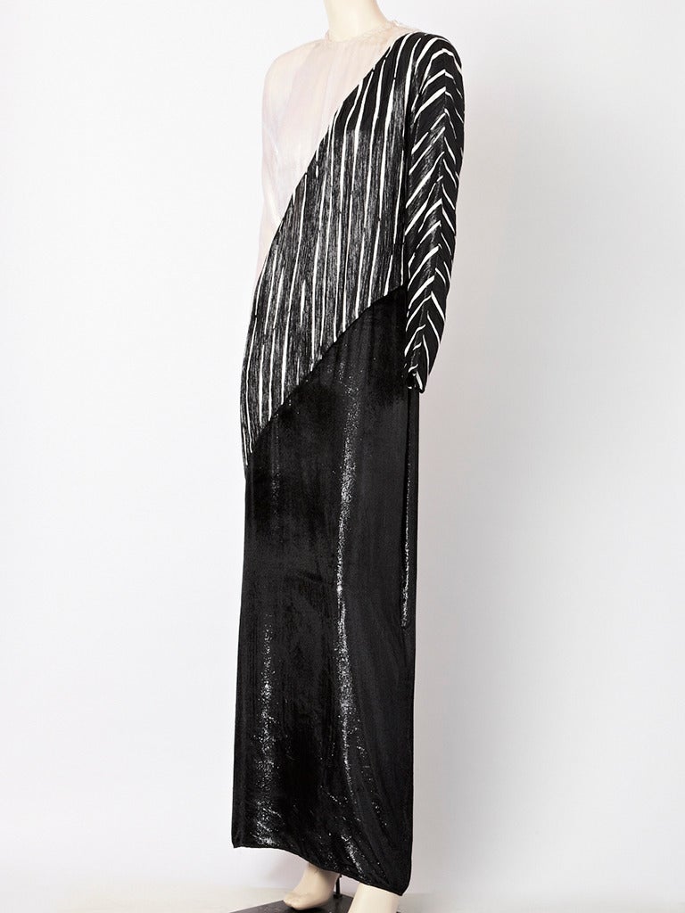 Geoffrey Beene, black and white, graphic, long sheath with 3  diagonally placed fabrics of different textures. Top, is one shoulder of white velvet. Middle is a black and white lame and the bottom layer is a shimmery velvet.