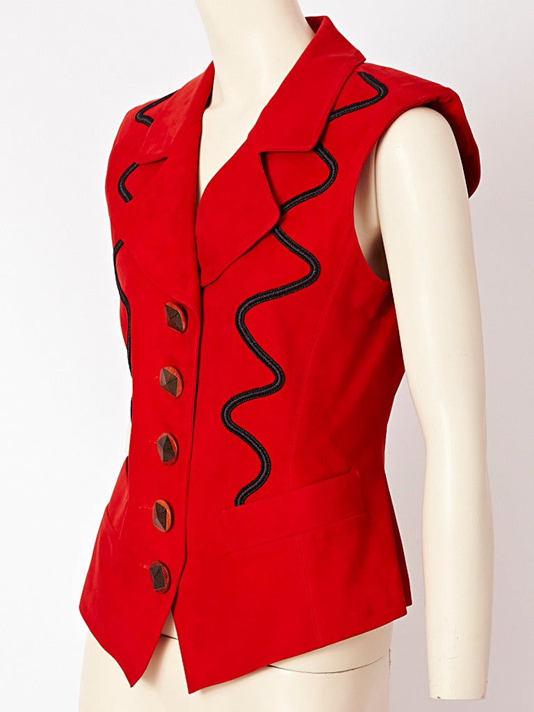 Yves Saint Laurent, red suede sleeveless  jacket/vest with black passementerie,
embellishment.