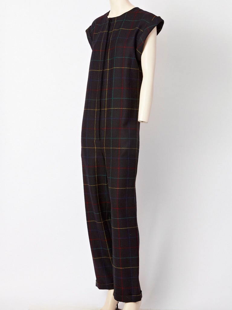 Karl Lagerfeld, for Chloe, wool plaid, jumpsuit. Jumpsuit has no waist, but can be worn belted . Black background with a red, green and yellow plaid.
Jumpsuit buttons down the front with hidden buttons. Cap sleeve, with folded cuff and cuffs at the