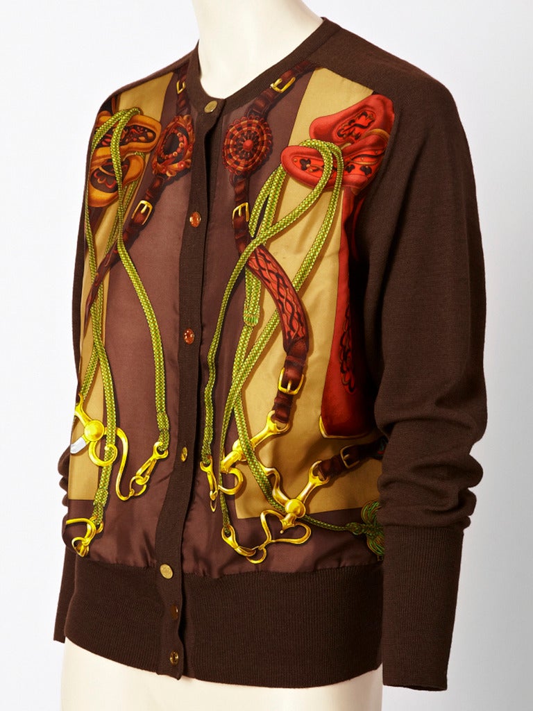 Hermes, silk, wool, and cashmere, cardigan. Cardigan has front panels of a silk 
horse themed print. Knit part of the sweater is a blend of 65% cashmere and 
35% silk. Gold toned 