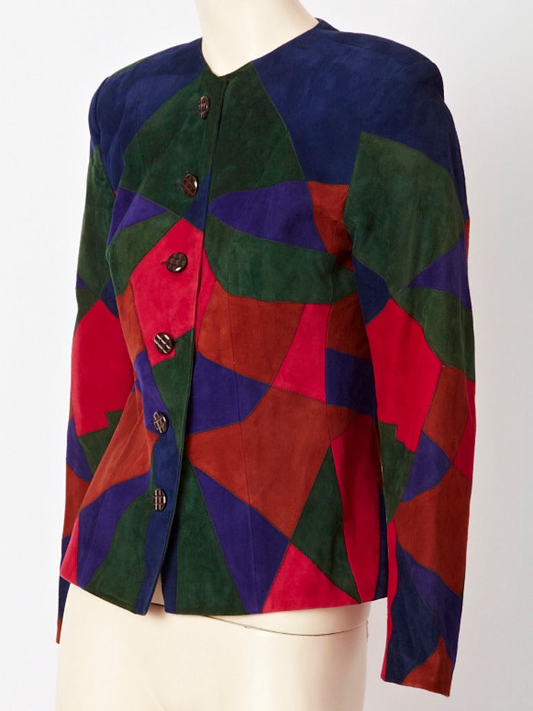YSL, fitted, collarless, patchwork, suede jacket in rich tones of reds, purple,and dark green. Slightly padded shoulder.