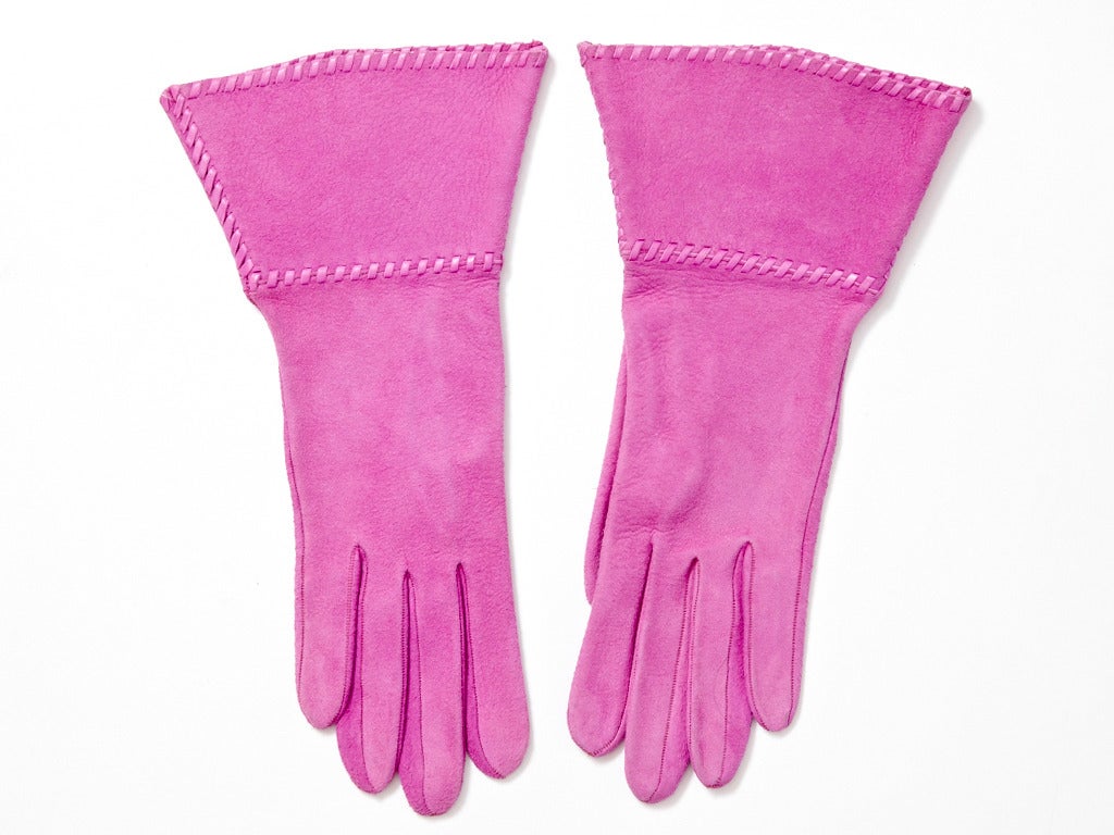 Yves Saint Laurent, fuchsia, suede gauntlet gloves trimmed in leather diagonal stitching. 