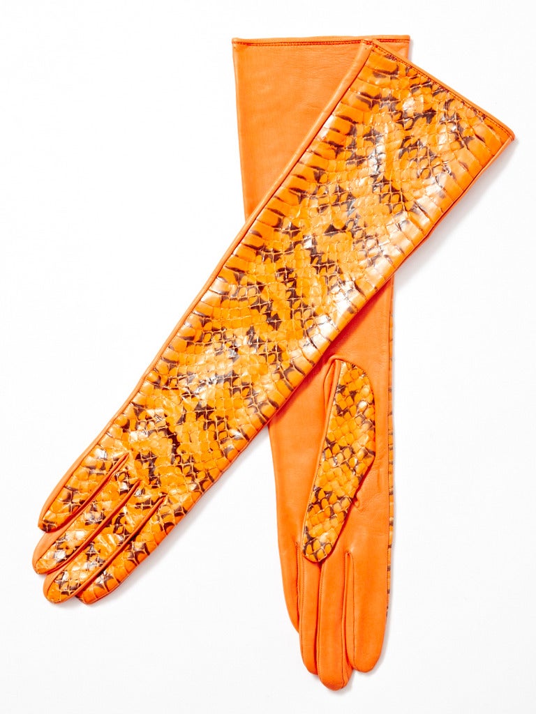 YSL, orange, leather and python, 3/4 length gloves. Python on the front side of the glove and kid leather on the back side.  