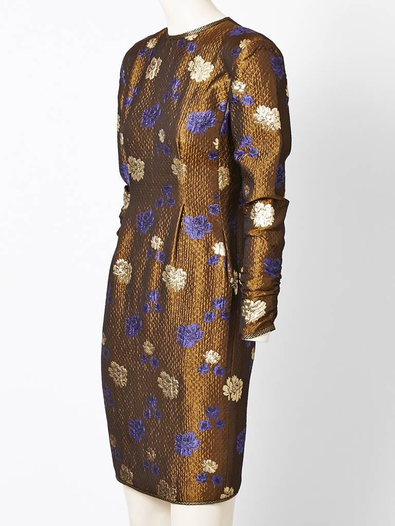 Geoffrey Beene, copper tone, Matelasse , brocade dress having a jeweled neckline, fitted bodice and long sleeves..Dress has has a lovely floral Asian inspired pattern. Exquisite fabric..
