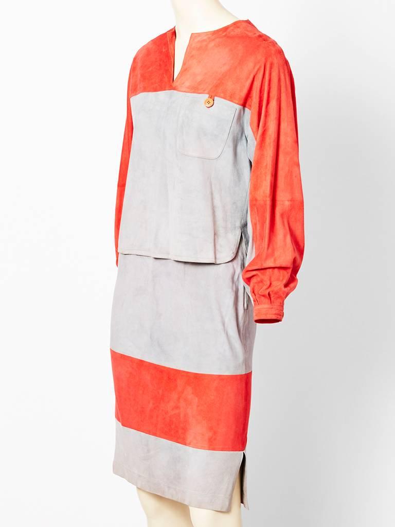 Gucci, coral and grey, ultra soft, suede ensemble. Two tone, casual over shirt top has a single pocket . Straight skirt, is also 2 toned with slight gathering at the waist with side slits at the hem. 