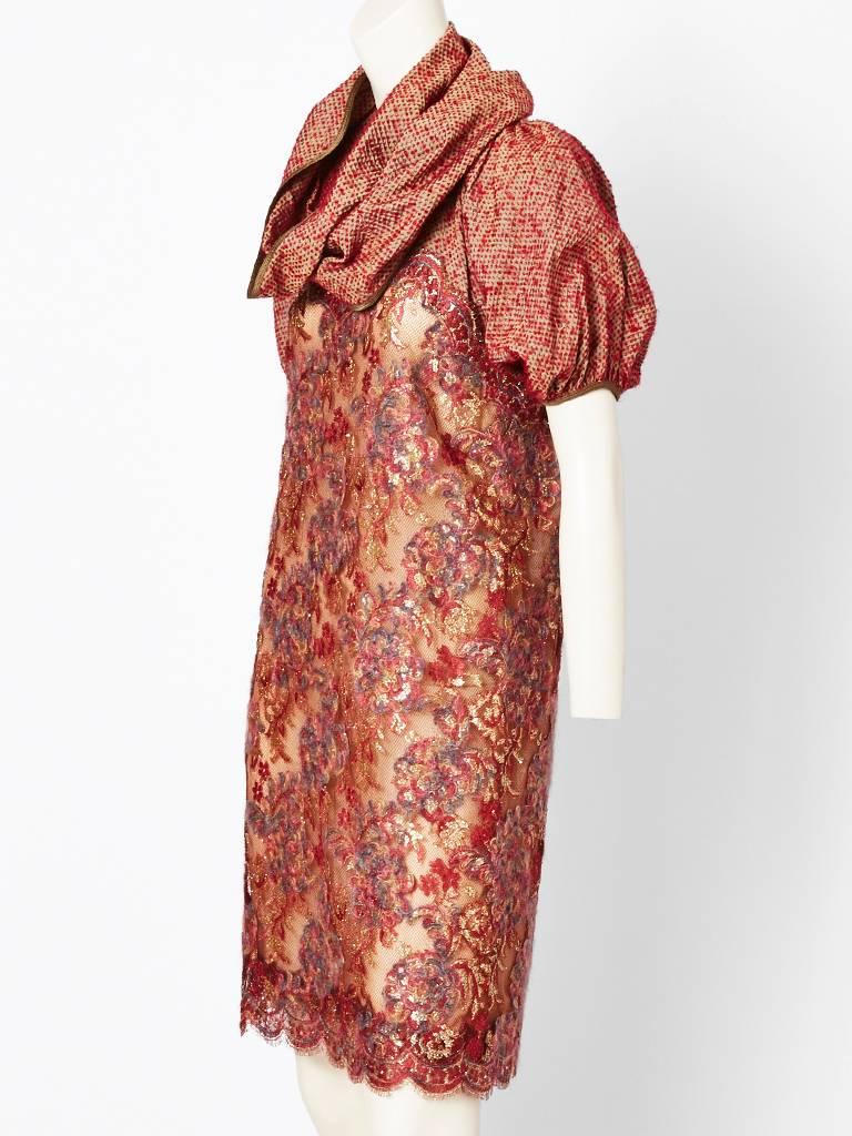 Geoffrey Beene, rust tone, with gold, lace dress with scalloped hem. Upper bodice has a pouf sleeve and rounded neckline made in a textured silk fabric, resembling a 