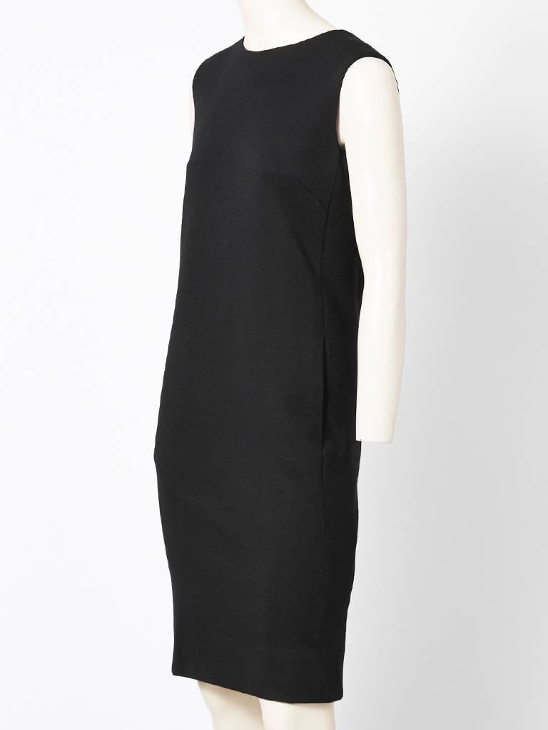 Norman Norell, black wool knit , sheath having a back button closure and  hidden side slash pockets. C. 1960's