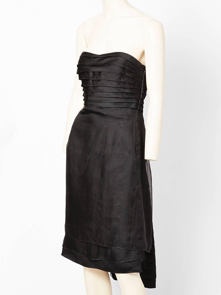 Christian Dior, chiffon and hammered silk satin, strapless cocktail dress. Bodice has a horizontal, pleat like bodice in hammered silk satin
having a ruched back. Skirt has two layered tiers of silk chiffon. Back has a 