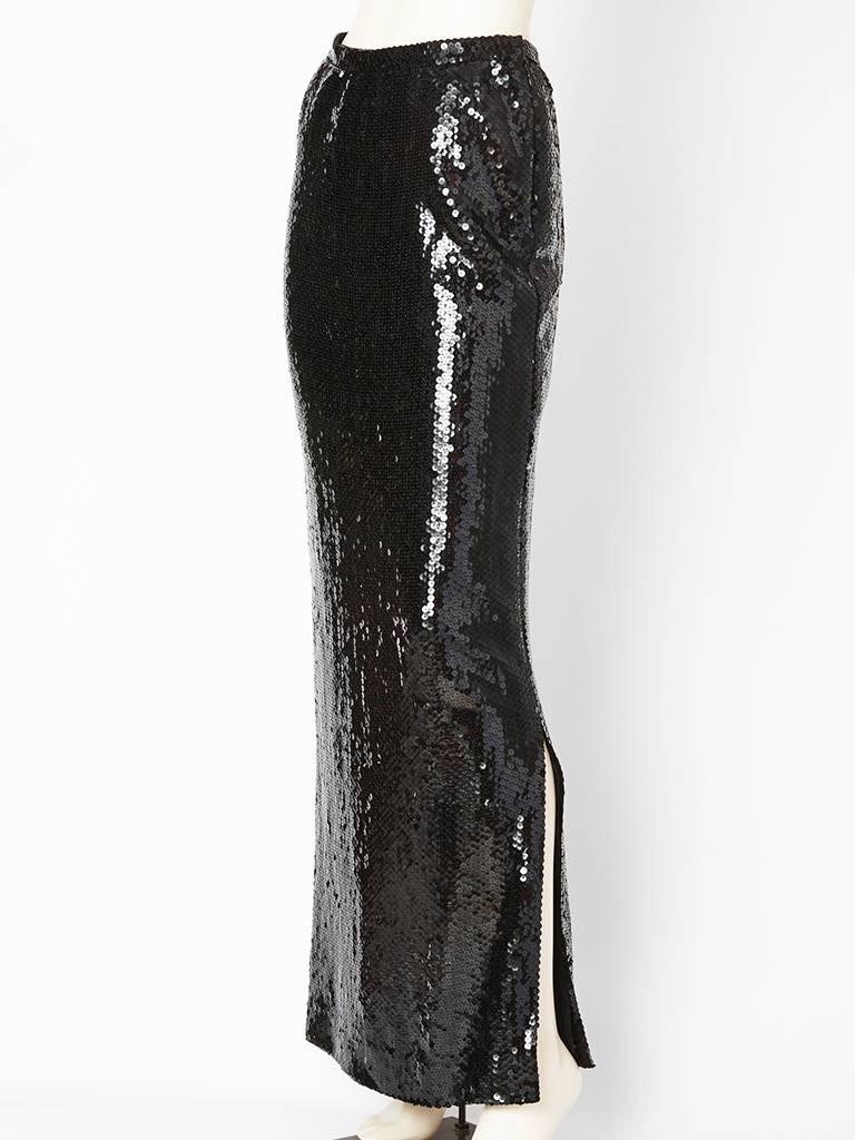 Bill Blass, long, black, sequined, straight evening skirt with a deep side slit on the left side. Zipper, closure on the left. Lined in silk.