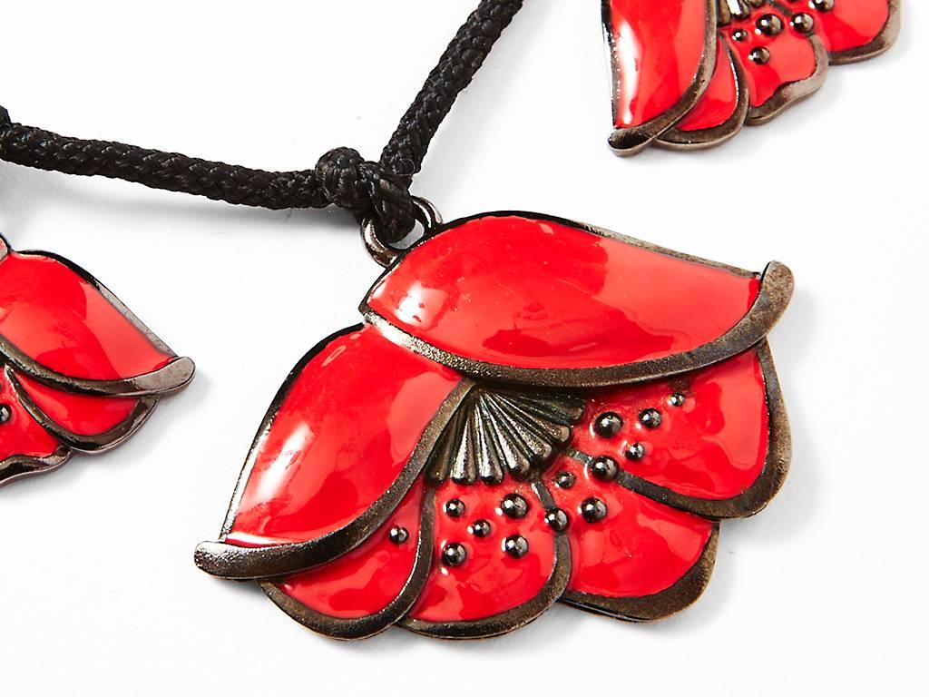 Yves Saint Laurent, necklace on cord of 3 painted, raised, metal poppy flowers.