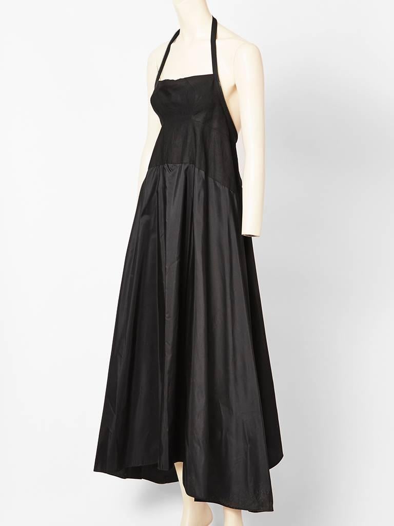 Shamask, taffeta and linen, zipper,  halter neck dress with empire waistline. Itnteresting placement of zipper.. starting from the lower back to mid back. Boning across the bust keeps the shape of the bodice of the dress. Back is exposed.