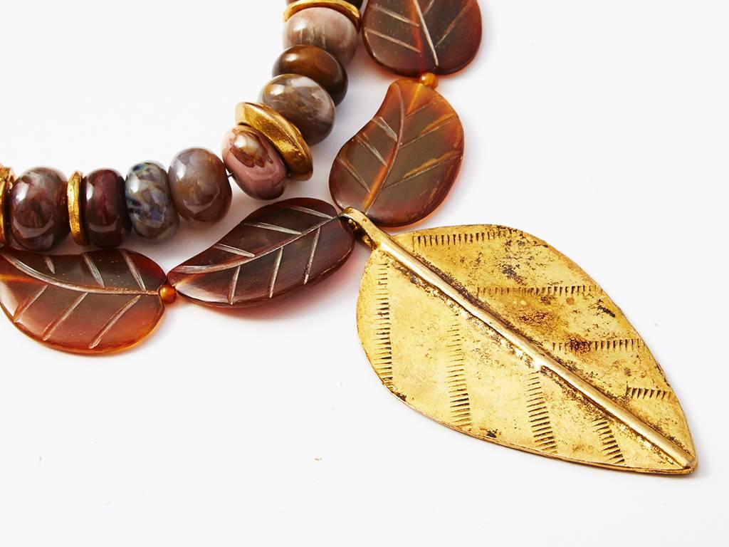 Yves Saint Laurent, rive gauche, double strand necklace. One strand is carved stone with a leaf motif. Large gold single leaf 