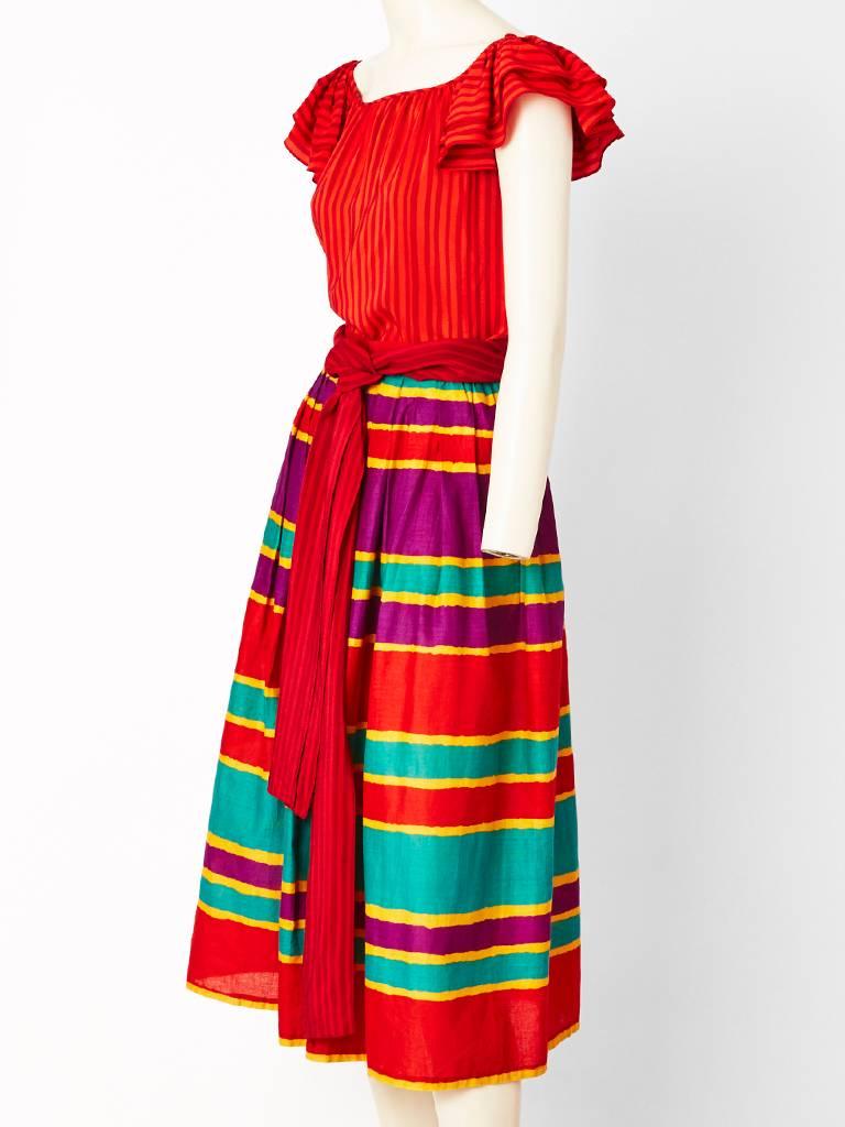 Miss O, ( Oscar de la Renta) 2 piece ensemble, having a silk, stripe, top with a ruffle sleeve and matching sash. Top can be worn off the shoulder. Skirt 
has a horizontal stripe pattern, made of cotton with gathering at the waist. 