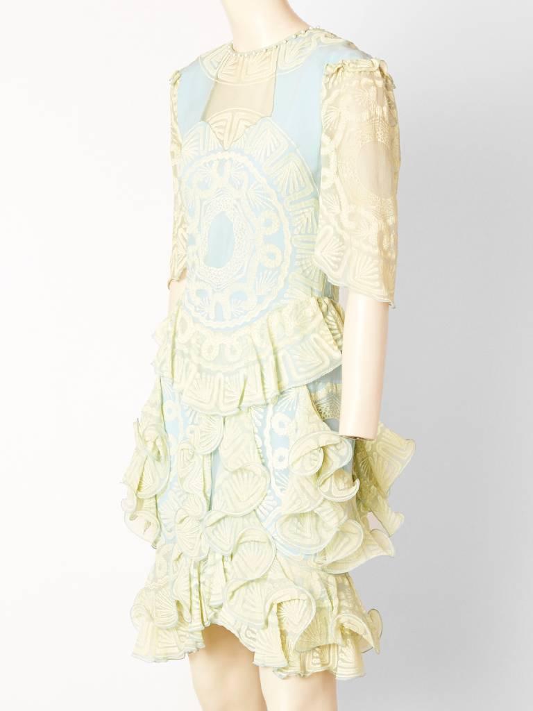 Zhandra Rhodes, ivory and pale blue, stenciled print, chiffon, drop waist dress, with pearl detail at the neckline. Skirt of the dress has ruffles, vertically placed.
Small ruffle detail at the shoulder. 1983. 