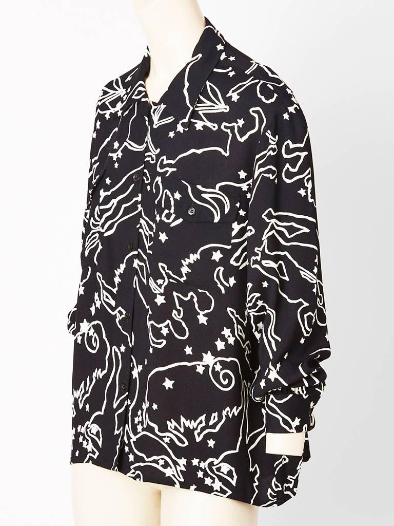 Yves Saint Laurent, black and white, zodiac print, crepe blouse with pointed, 
collar and full sleeves..
