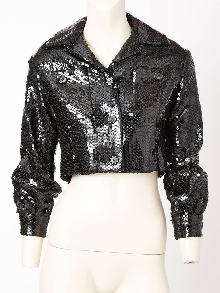 Bill Blass, black sequined, cropped jacket, having lapels, breast pockets, button closure and cuffed sleeves. C. 1970's.