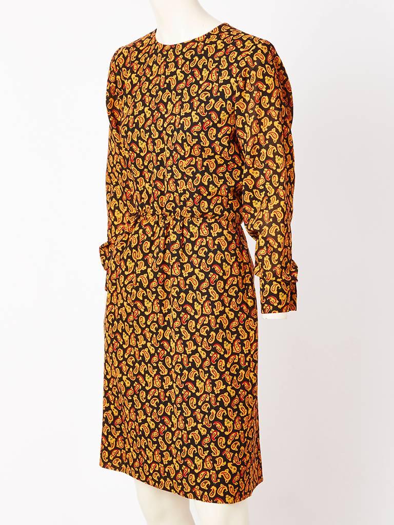 Yves Saint Laurent, wool challis, paisley print, day dress, having a jewel neckline, long sleeves, and a slightly gathered waist.
