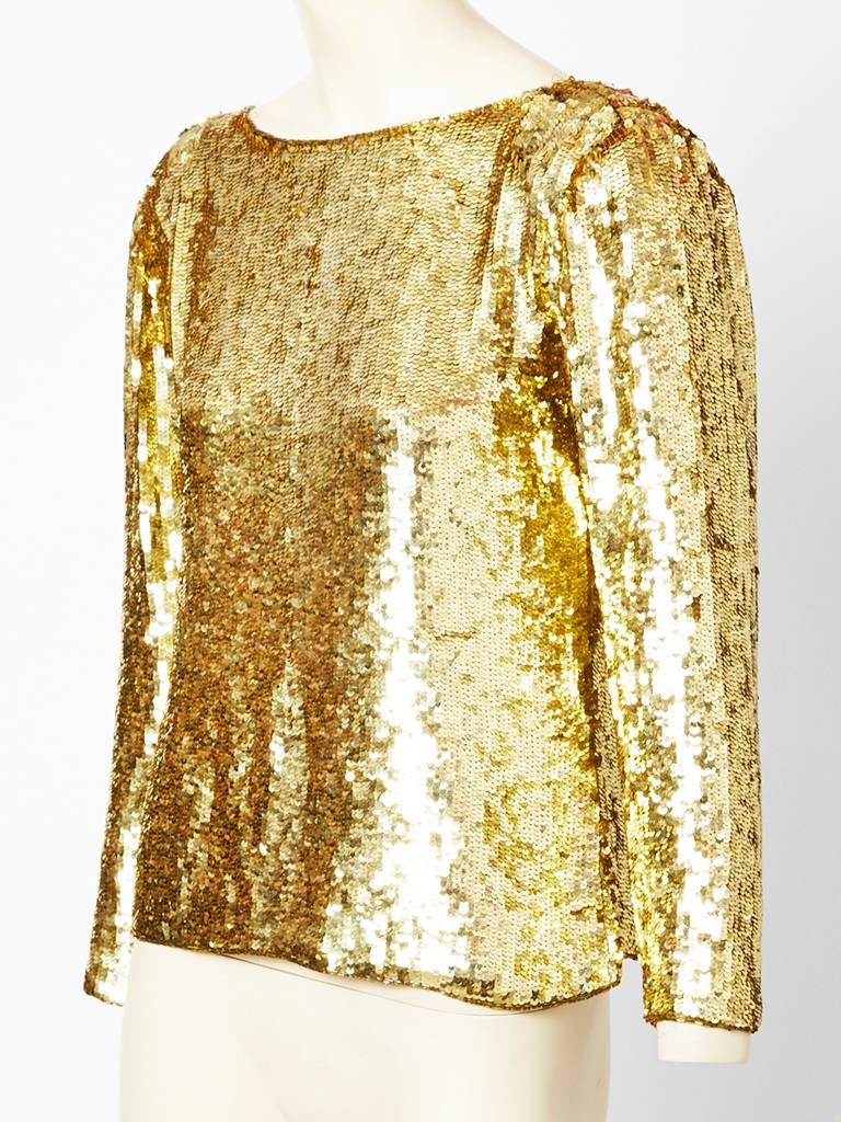 Yves Saint Laurent, gold evening top, encrusted with gold sequins.
Boat neckline with an open back with jeweled gold closures.
Lined in silk georgette.