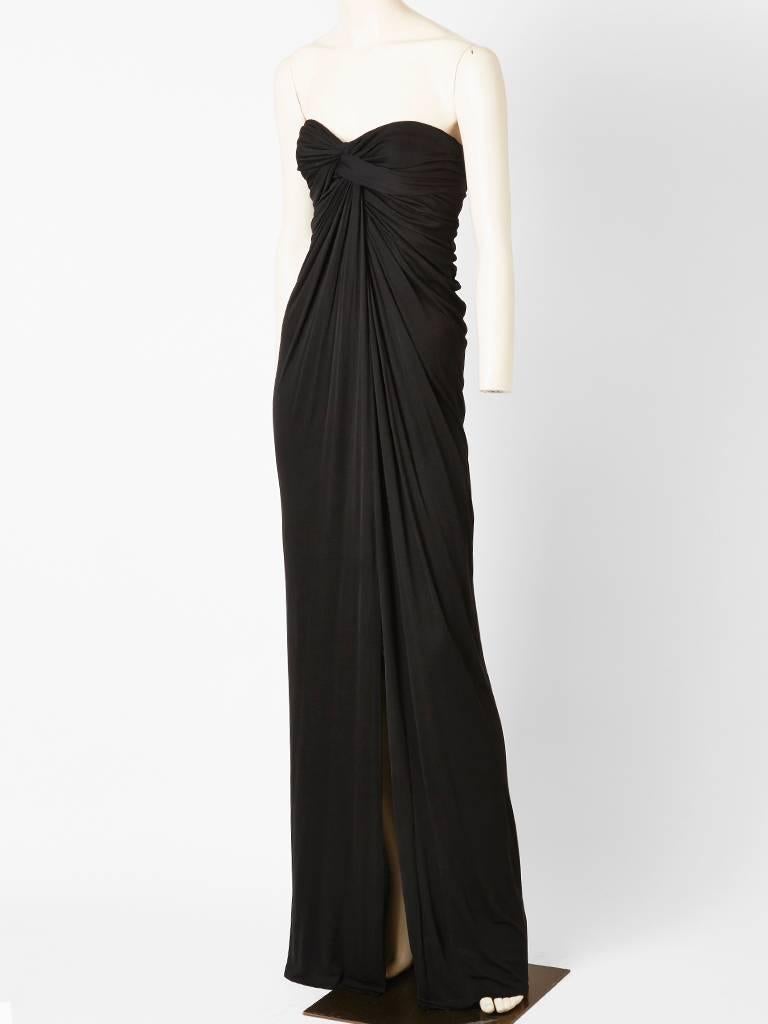 Stavropoulos, black matte, jersey, strapless, Grecian inspired gown, having draping detail from the middle bust to the hem. Dress has a built in corset.