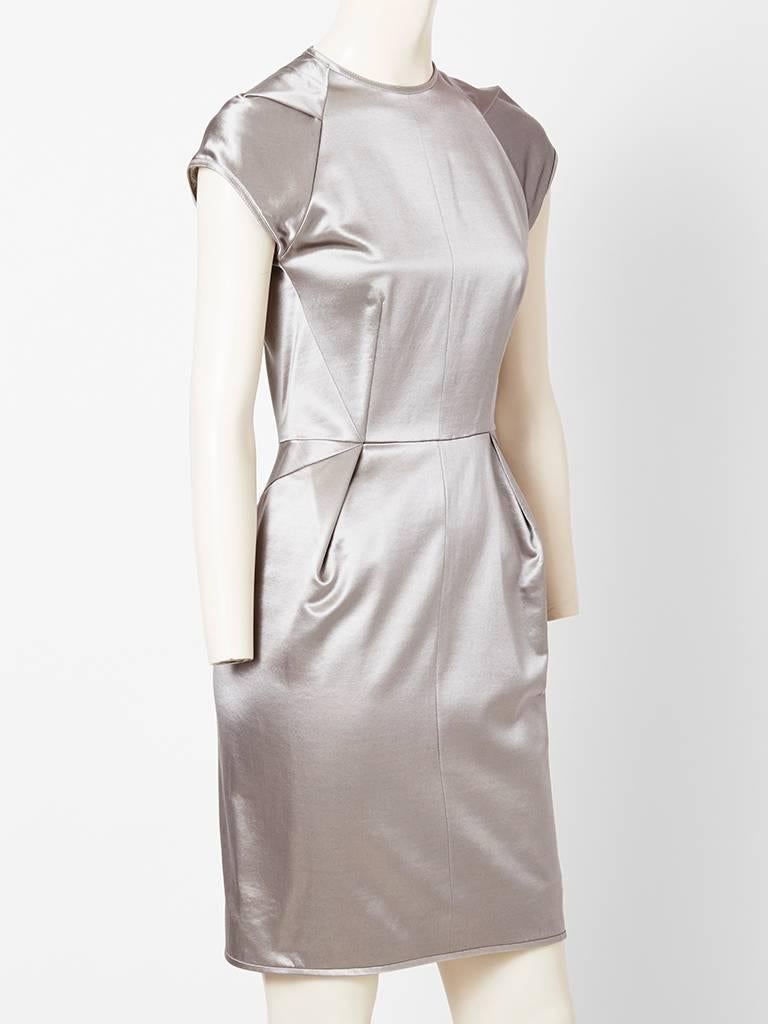 Goeffrey Beene, gunmetal, gray, sculpted, silhouette, duchess satin dress, having capped sleeves with a pleat detail at the shoulder and at the hip.