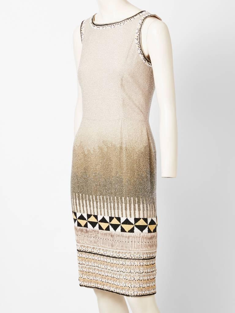 Oscar de la Renta, sleeveless, fitted, cocktail dress encrusted with crystal bead work. Bead work detail includes an ombre pattern at the thighs and African inspired motifs at the hem.