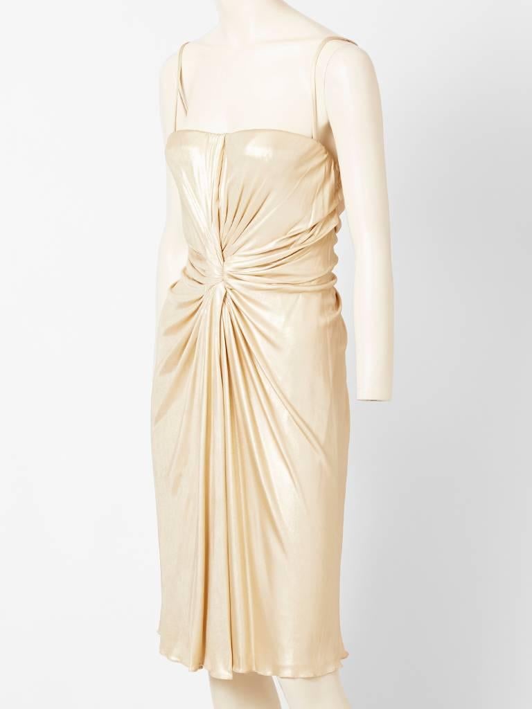 Christian Dior subtle, liquid, gold lame,  jersey, cocktail dress, having spaghetti straps and center front and back draping detail.