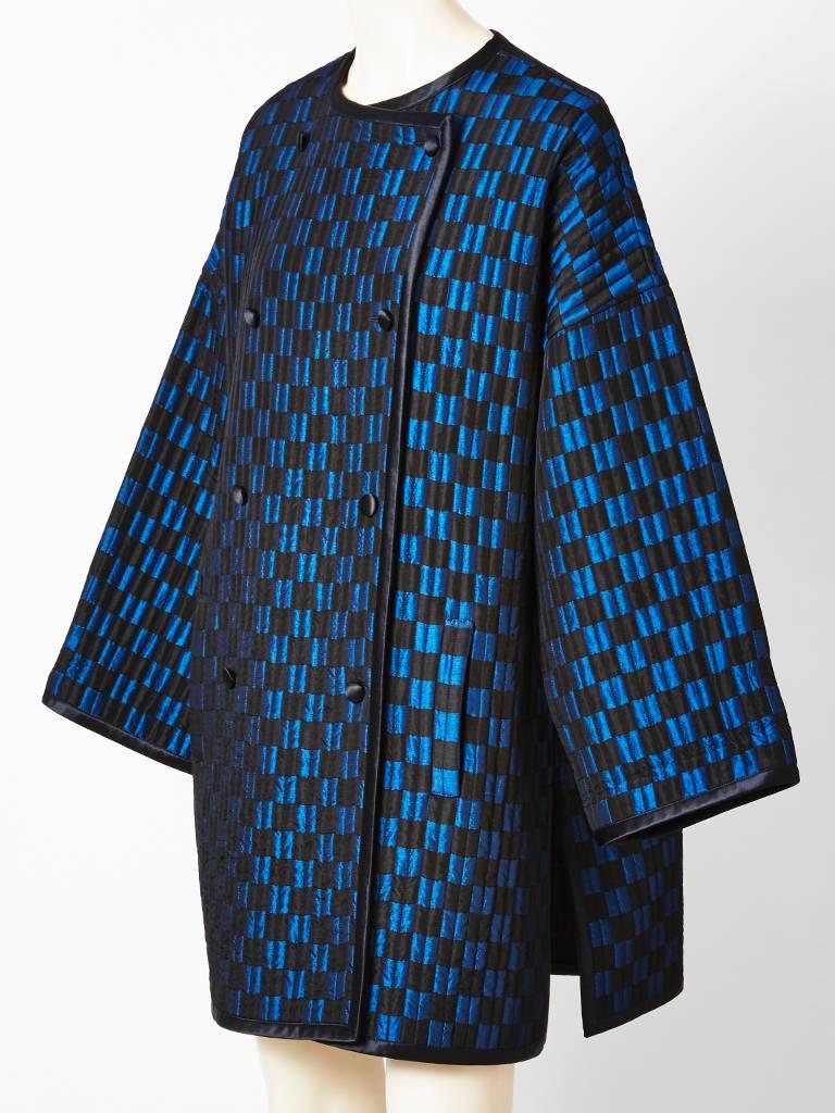 Geoffrey Beene, graphic, black and teal blue, check, collarless, satin coat, having a double breasted, closure and vertical quilting, creating a sculptural, effect. Lined and edged in black satin with side slits.