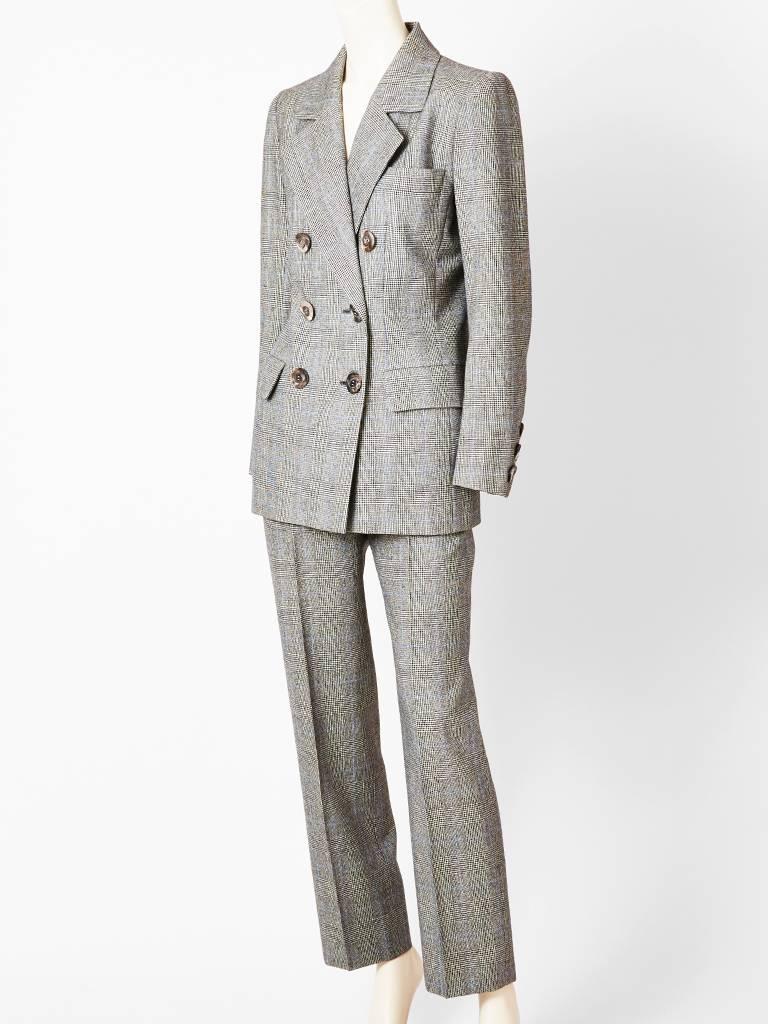 Yves Saint Laurent, Couture, Prince of Wales, plaid wool pantsuit.
Fitted jacket is double breasted with flap pockets at the fit.
P
