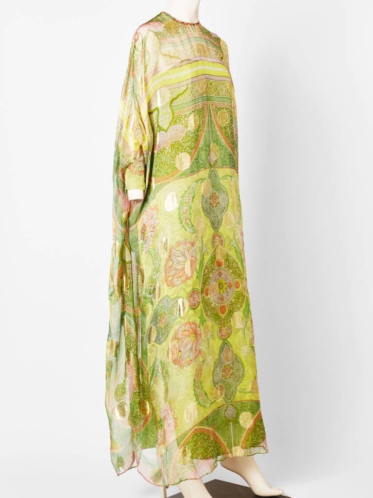 Adolfo, silk chiffon and gold lame, paisley patterned caftan with cuffed sleeves.
Dress has a silk slip in a complimentary shade of green. C. 1970's.