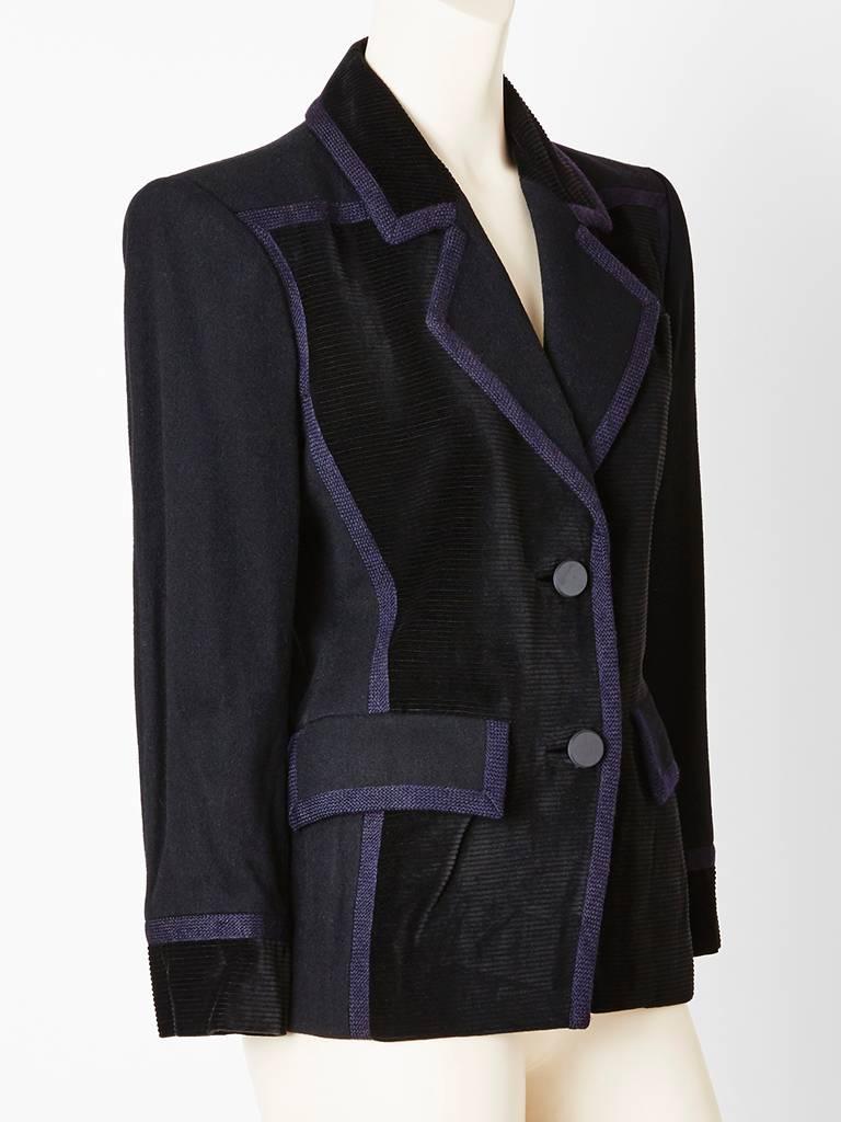 Yves Saint Laurent,black, wool blazer having corduroy panels on the front of blazer and passementerie trim detail.The upper lapel and cuffs are corduroy as well.  Jacket has front flap pockets.Beautifully cut with a nipped in waist.