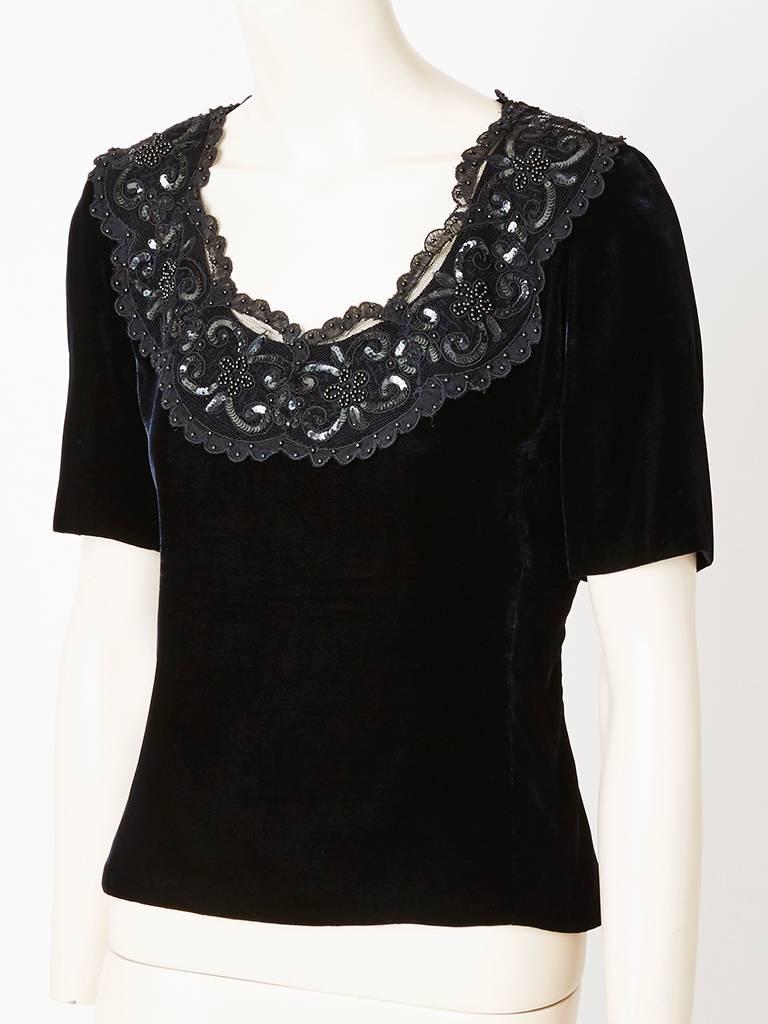 Yves Saint Laurent, Couture,  fitted, short sleeved, velvet top, having a scoop neck with lace, sequined and beaded detail.